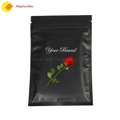 Black stand-up pouch with a red rose graphic and 'Your Brand' text on a white background.