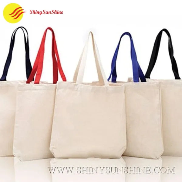 Set of cotton fabric tote shopping bags with handles in assorted colors
