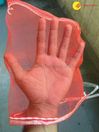 Folded mesh packaging bags with printed branding, ready for distribution