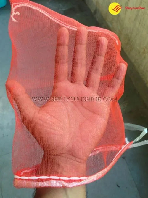 Folded mesh packaging bags with printed branding, ready for distribution