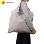 Eco-friendly polyester tote bag with custom branding, photographed in lifestyle setting