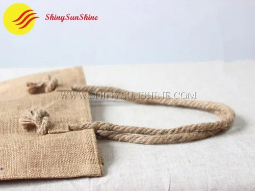Handles of  a custom branded jute tote shopping bag, portable and eco-friendly
