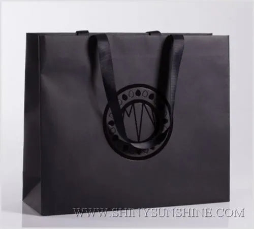 Close-up of paper bag texture showing printed branding and handle detail