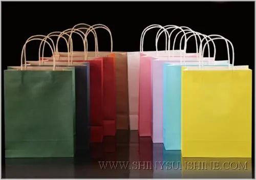 Colorful paper bags in various colors on a black background with a visible website address.