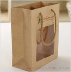 Kraft paper bag with a window and handle on a white background